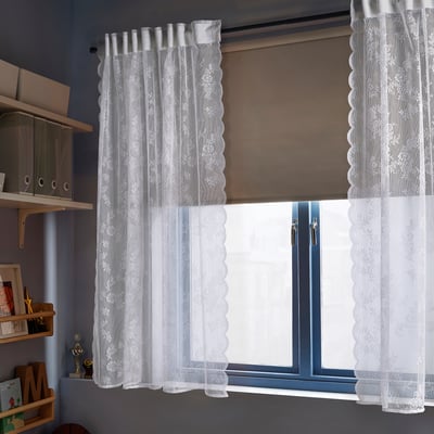 Lace curtains, ALVINE SPETS, on blue window. Surrounding shelves show size and design.