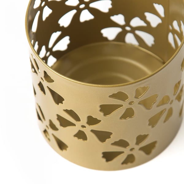Gold-colored metal tealight holder with intricate floral cutouts, showcasing high-quality design and craftsmanship.