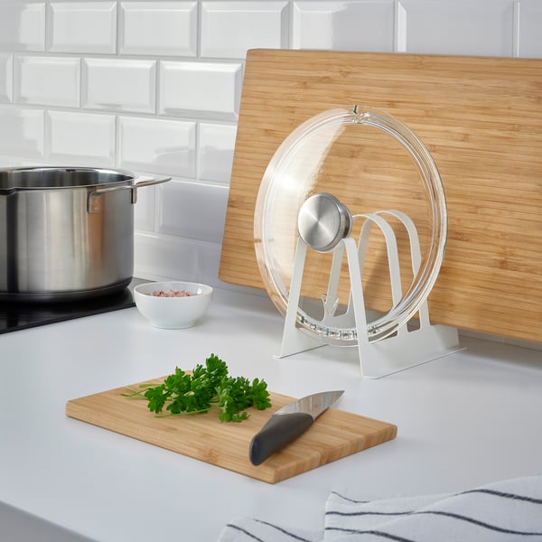 Kitchen counter with AVSTEG lid organiser and cutting board.
