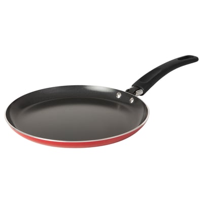 Red bakåvtolt pan, black handle, non-stick, circular shape, induction-friendly.