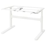 A white BERGLÄRKA adjustable desk stand with metal frame and plastic feet.