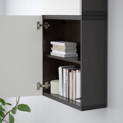 Black wall-mounted bookshelf with two shelves holding books.