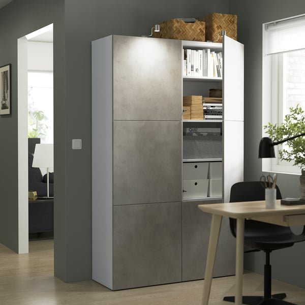 Modern room with a tall, grey and white BESTÅ storage unit featuring adjustable shelves, soft-closing doors, and organised compartments.