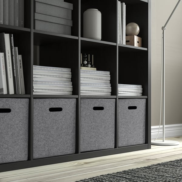 Black bookshelf with grey felt boxes and document stacks. Ideal for kallax shelving, offering organised storage in living spaces.