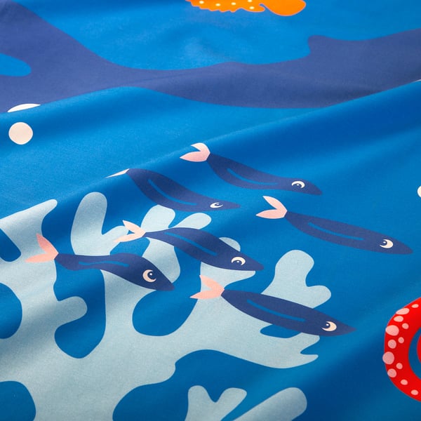 Vibrant ocean print sheet, soft cotton blend, fish, coral, smooth texture.