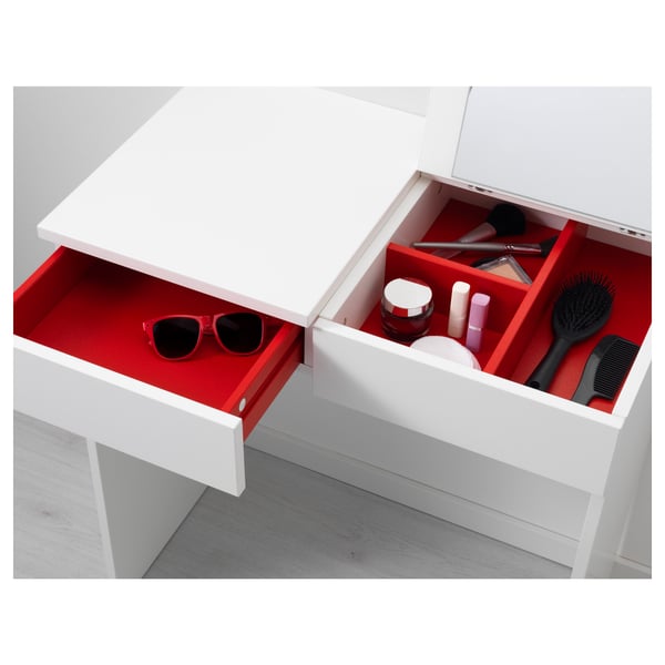 Red vanity drawer with cosmetics and grooming items.