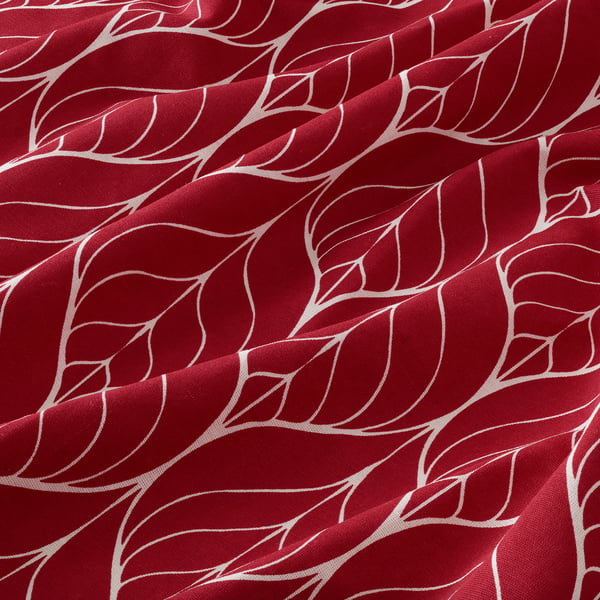Red patterned cotton fabric with swirling white design.