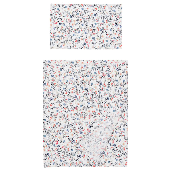 Two white sheets with floral patterns in blue and orange, one rectangular, one square.