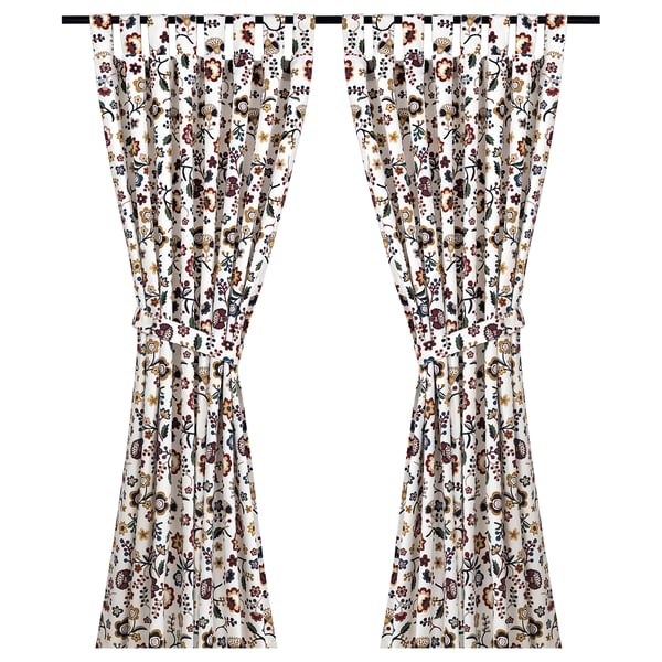 BRUNÖRT floral curtains, white with red, yellow, and blue flowers. Made from 100% cotton with tab headings.