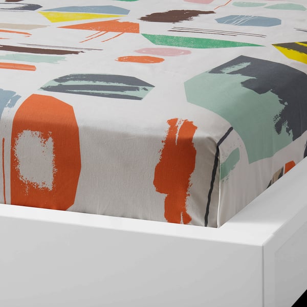 Bed sheet with colourful abstract prints, crisp white edges, folded neatly.