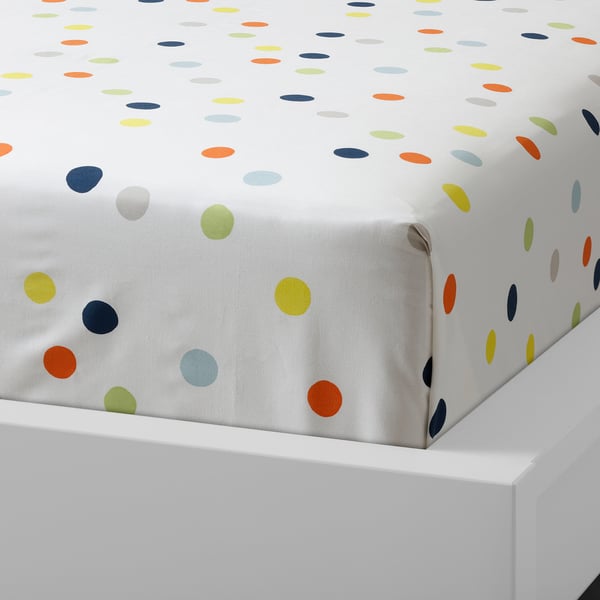 White bed sheet with colourful dots, representing a high-quality, durable cotton design.