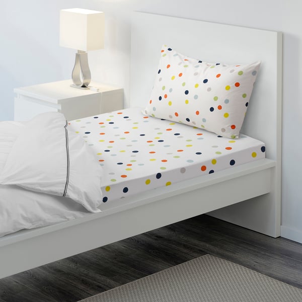 Polka dot bed sheet set on white bed, includes pillowcases. Colourful dots, tight weave, and cotton material.