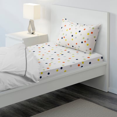 Polka dot bed sheet set on white bed, includes pillowcases. Colourful dots, tight weave, and cotton material.