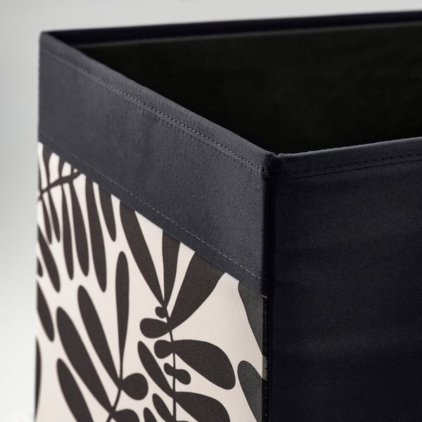 Close-up of a sturdy fabric storage box with black and white leaf pattern, showcasing its quality stitching and design.