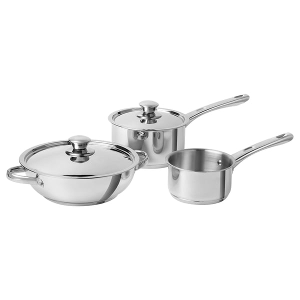Three-piece stainless steel cookware set: wok, saucepan, and small pot, polished silver, round shapes with flat bases and lids.