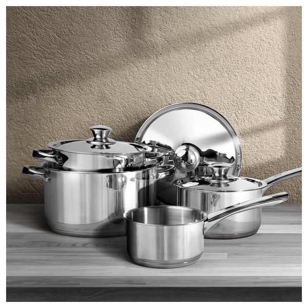 Stainless steel pots & pans set with lids on wood for any hob.