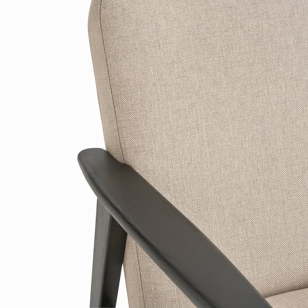 Close-up of sleek, modern chairs armrest & fabric in neutral tones, showcasing quality & design.