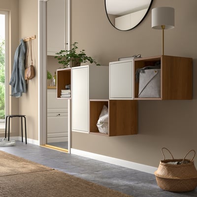 Modern entryway with EKET cabinets, lamp, coats, and basket.