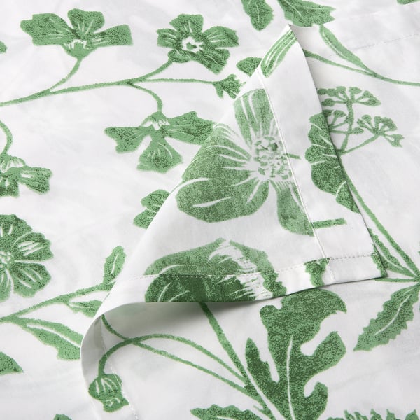 Foliage-patterned white fabric, soft and textured, close-up shows high-quality stitching and natural materials.