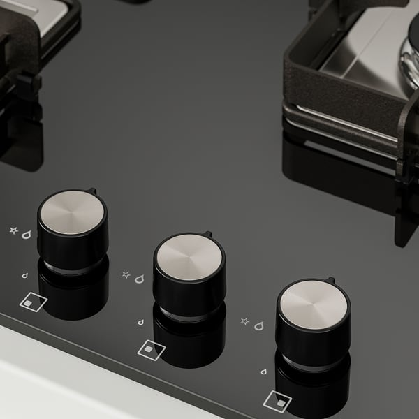 Modern gas hob with three metallic knobs, control panel, and sleek black surface.