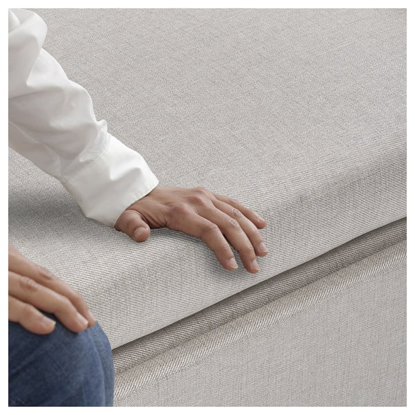 Image displays a hand on gammalyn grey sofa-bed with white sleeve.
