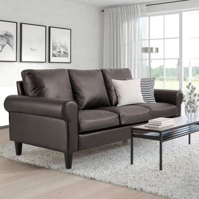 Modern living room with GAMMALBYN grey sofa, pillows, coffee table, rug, and large window.