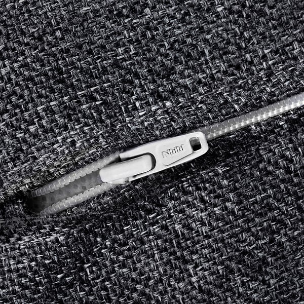 Close-up of grey fabric with sturdy, silver ykk zip, showcasing high-quality texture and detail.