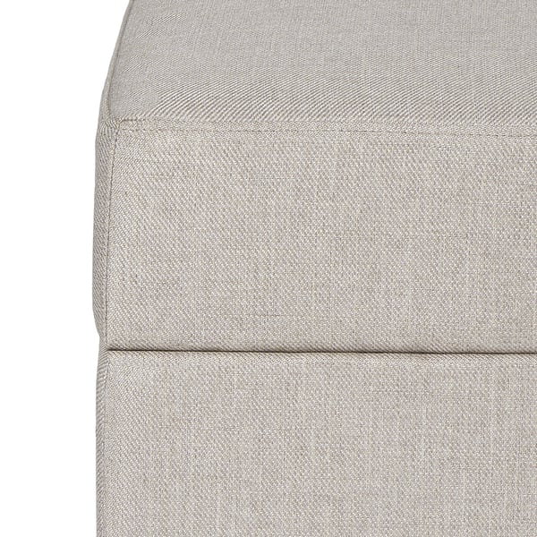 Close-up of grey gammalyn footstool cushion. Soft, textured fabric with clean, neatly stitched edges. Invites comfort and support.