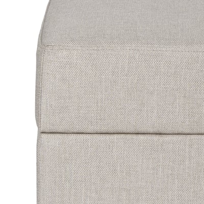 Close-up of grey gammalyn footstool cushion. Soft, textured fabric with clean, neatly stitched edges. Invites comfort and support.