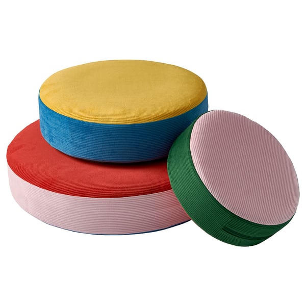 Three colourful, circular cushions in yellow, blue, and red, stacked in a pyramid. Bright and playful design, made from recycled polyester.