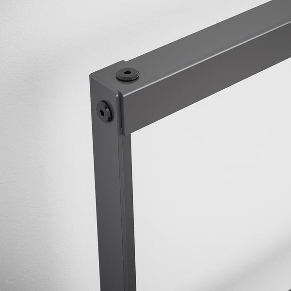 Close-up of a sturdy grey steel bed frame corner, securely fastened with bolts.