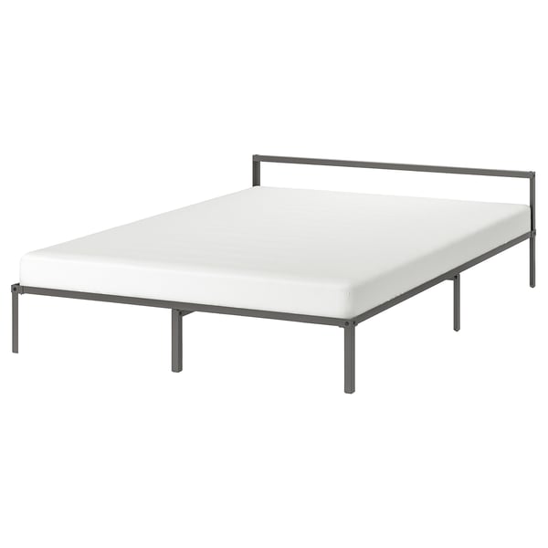 A GRIMSBU bed, white with a steel frame, featuring a low, square design.