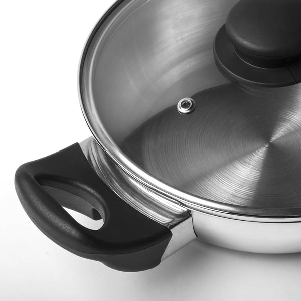 Stainless steel wok with glass lid & black handles.