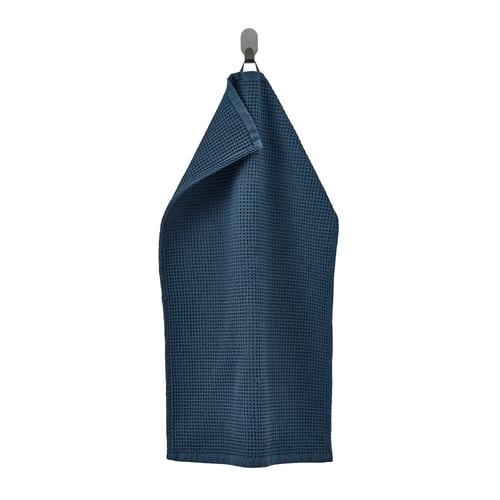 A navy blue GULLDYNA towel hanging on a hook, made of 100% cotton, rectangular with a textured weave design.