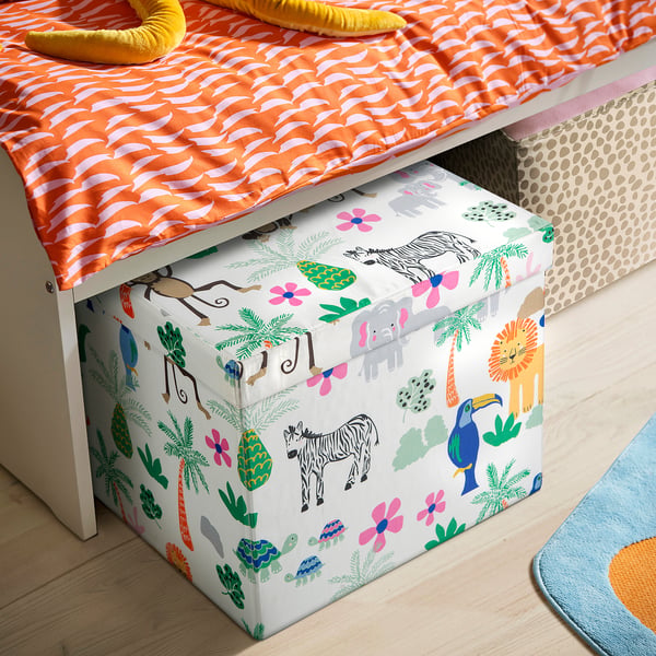 Orange & white striped bedding with yellow toy and colourful box. Playful kids room.