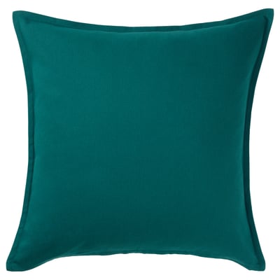 A GURLI cushion in teal colour. It is square-shaped with clean lines and made from 100% cotton.