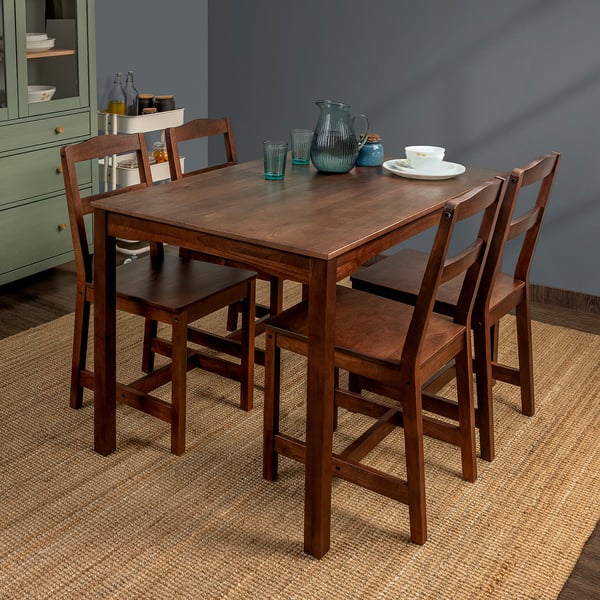 A HÄGERNÄS brown dining set with a square table and four matching chairs in solid mango wood, perfectly fitting under the table.