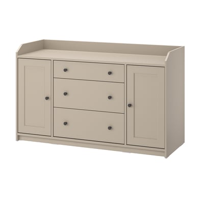 A light-colored wooden cabinet with three drawers and two side doors, providing storage space with a classic design.