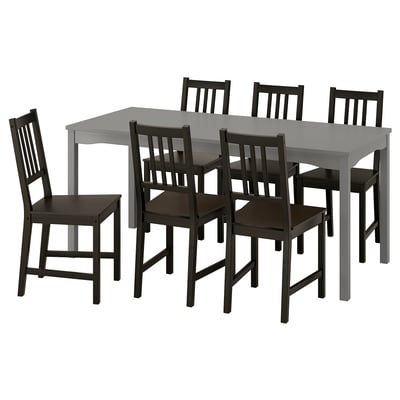 Grey HAUGA dining table with 6 black stefan chairs, veneer top, wooden seats. Cosy dining setup.