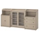 A beige HAUGA storage unit with a mix of open and closed shelves, glass doors, and three drawers.