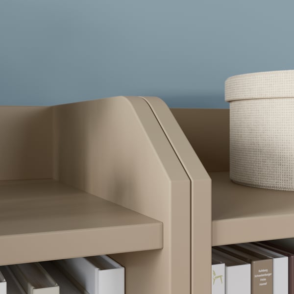 Modern beige storage unit with shelves and a fabric bin by IKEA.