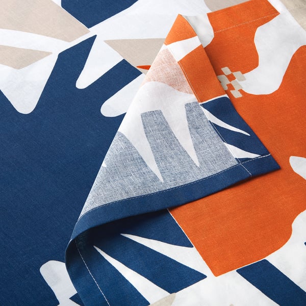 Vibrant patterned fabric close-up, showcasing intricate designs and vivid colours.