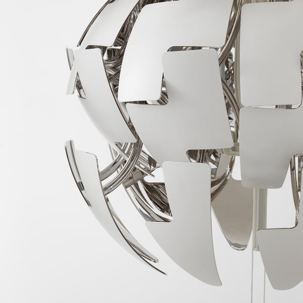 Modern chrome lamp with white blades radiating from central hub. Elegant, sleek design.