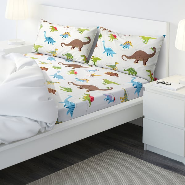 Dinosaur-themed kids bedding with colourful dinosaur designs on sheets and pillowcases.