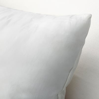 Plush, plump pillow with smooth, woven fabric texture, highlighting its luxurious, supportive quality.
