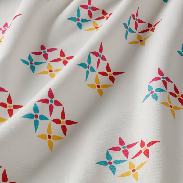 Bright floral patterned curtain, white background, colourful.