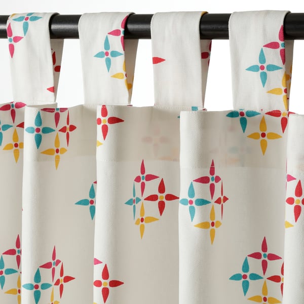 Floral curtains hang from black rod, easy instal tab, reduce light, provide privacy.