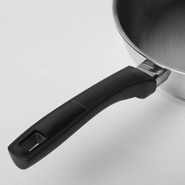 Black plastic handle of stainless steel frying pan