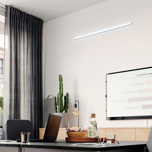 Modern office with led light, laptop, plants, and report display.