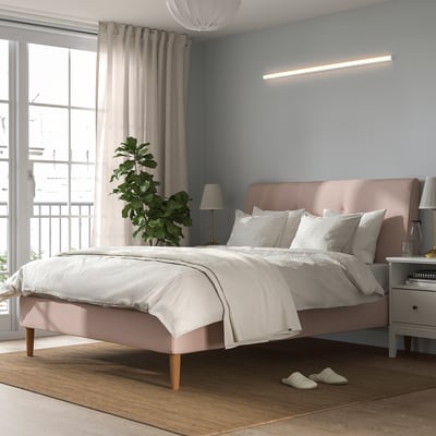 Modern bedroom with led light, bed, window, plant, nightstands.